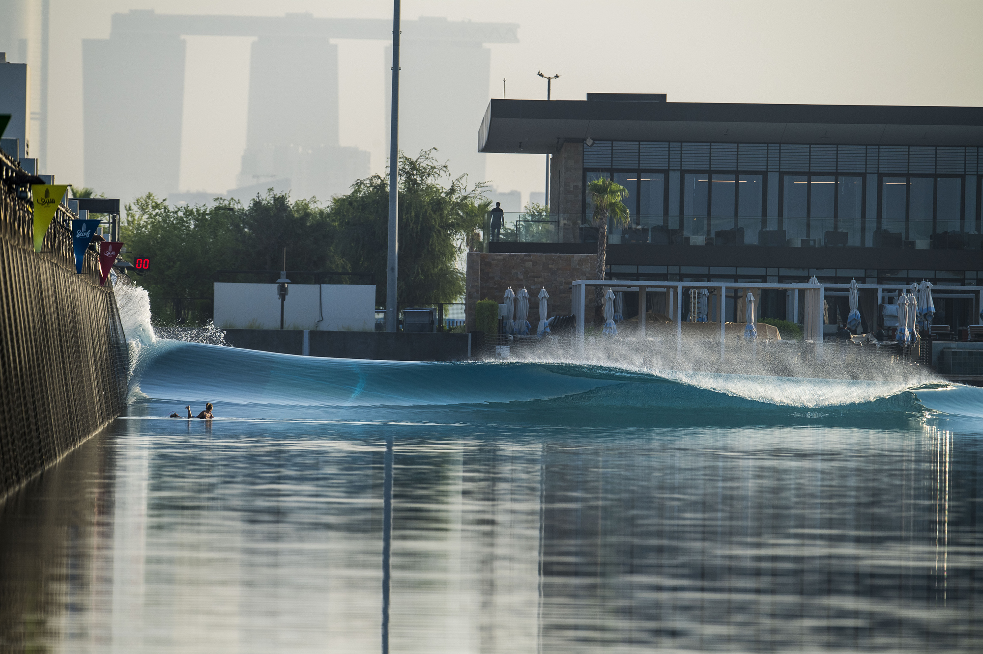 View of Surf Abu Dhabi wave pool and Surf Club with Abu Dhabi skyline